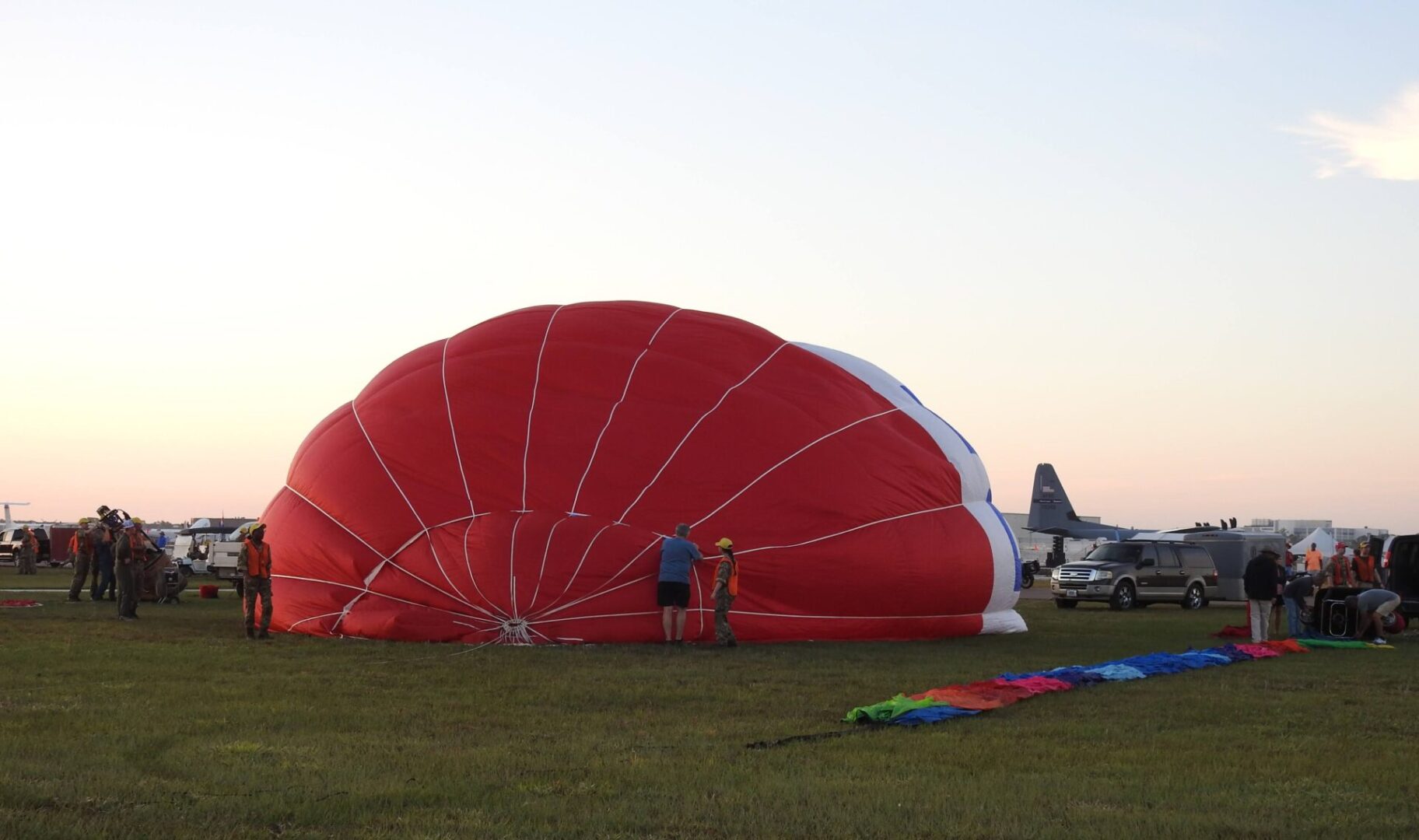 A person standing next to an open parachute.