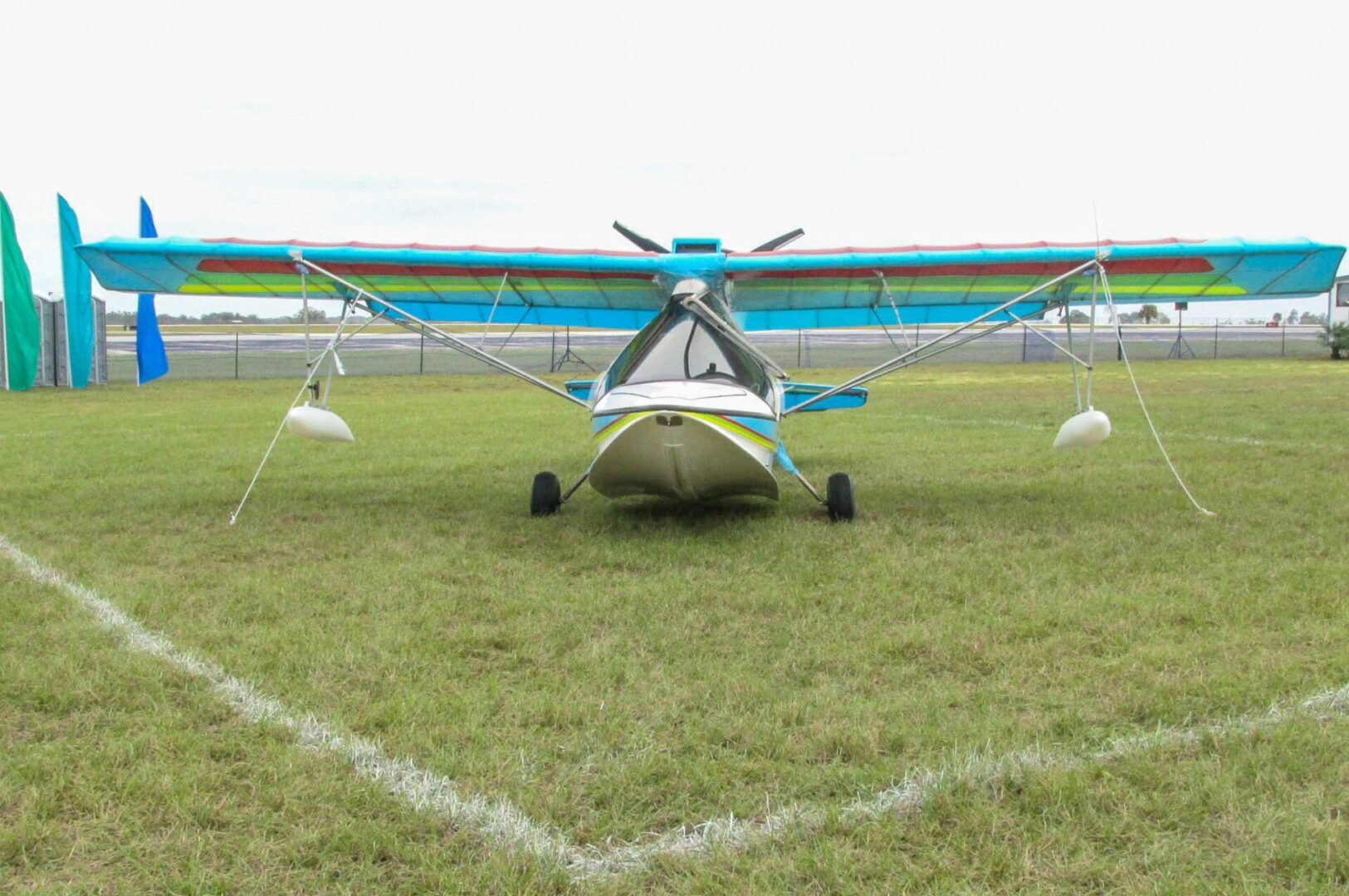 A small airplane sitting on top of an open field.