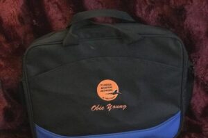 A black and blue bag with an orange circle on it.