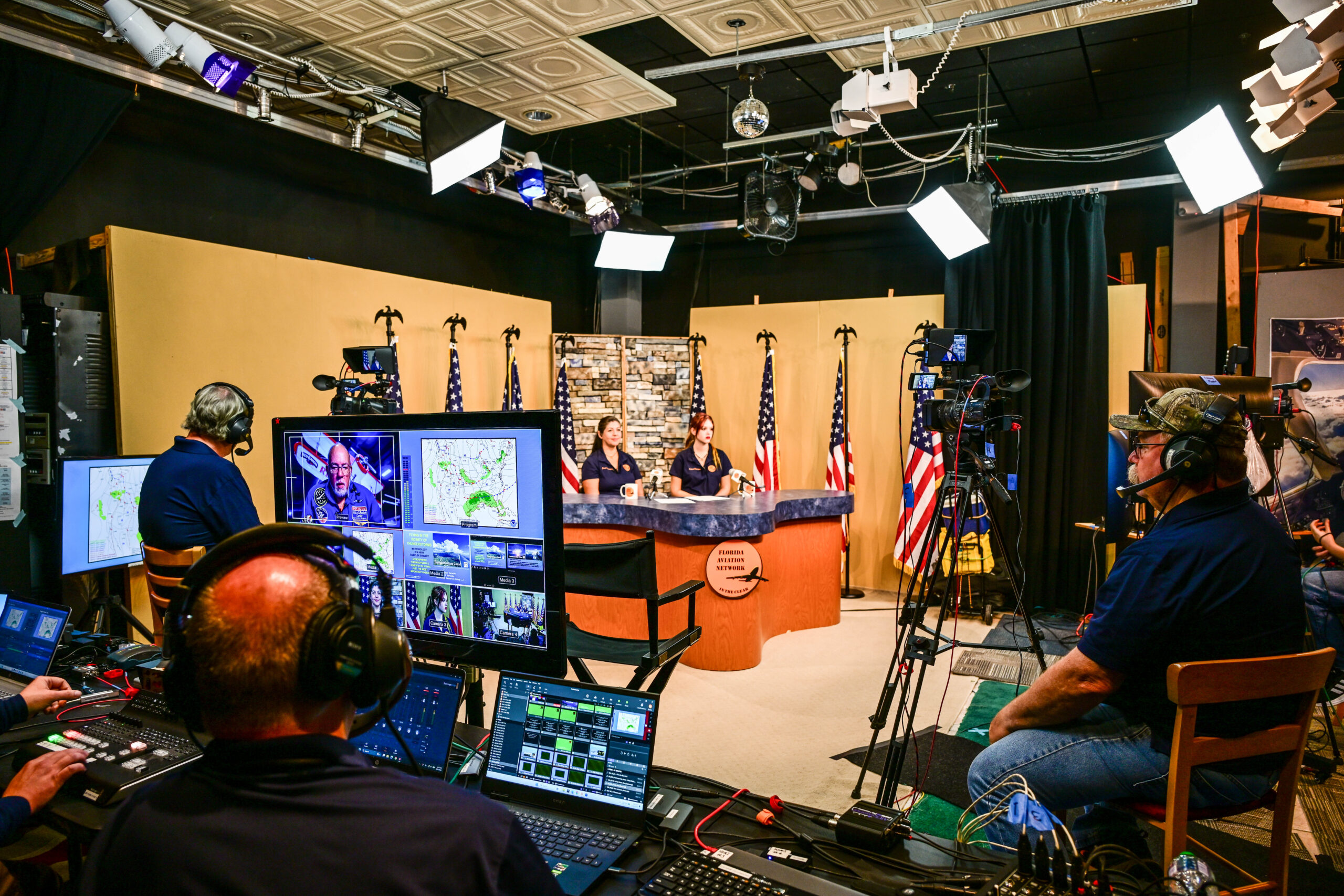 News anchors filmed in studio with crew